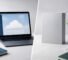 Split desk scene contrasting a cloud-ready laptop with a perpetual software box — Microsoft 365 vs Office 2024