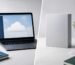Split desk scene contrasting a cloud-ready laptop with a perpetual software box — Microsoft 365 vs Office 2024